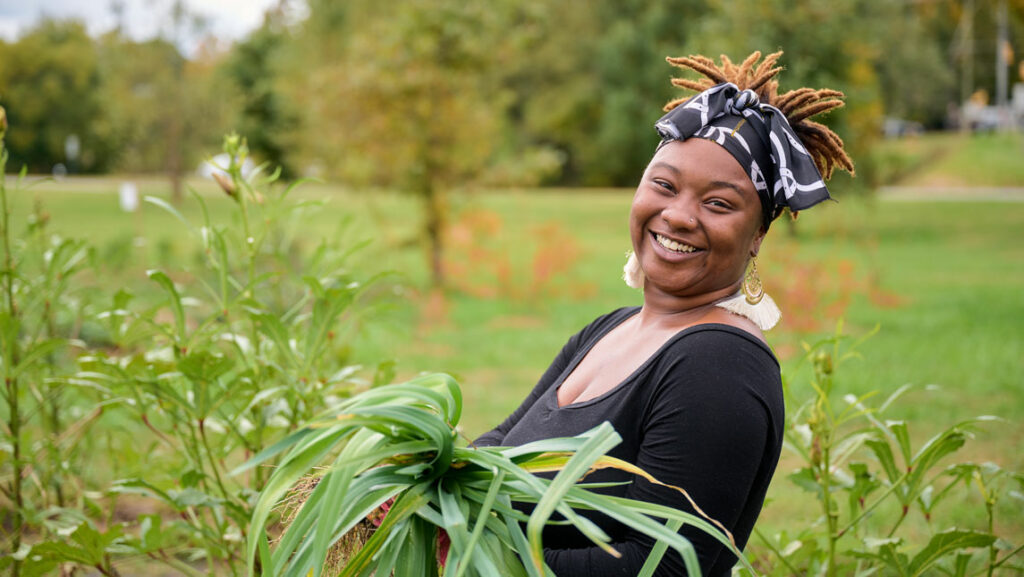 woman holding harvested crop in a green garden