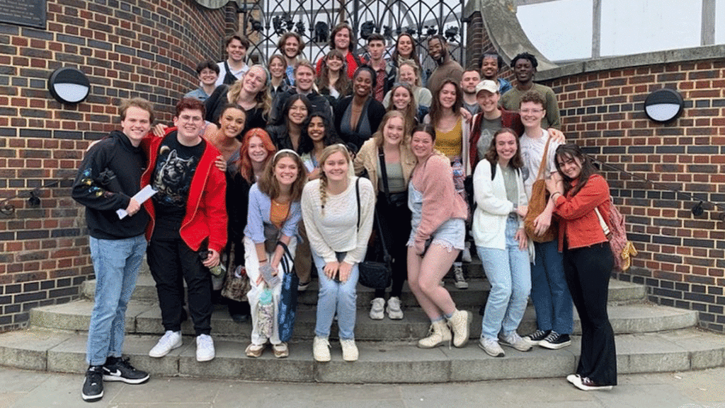Students pose on the outside of London theatre for study abroad in London 