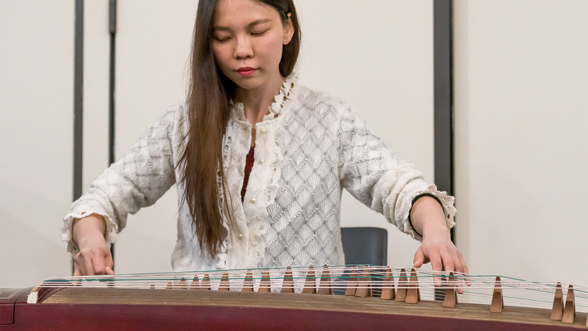 Student playing musical instrument