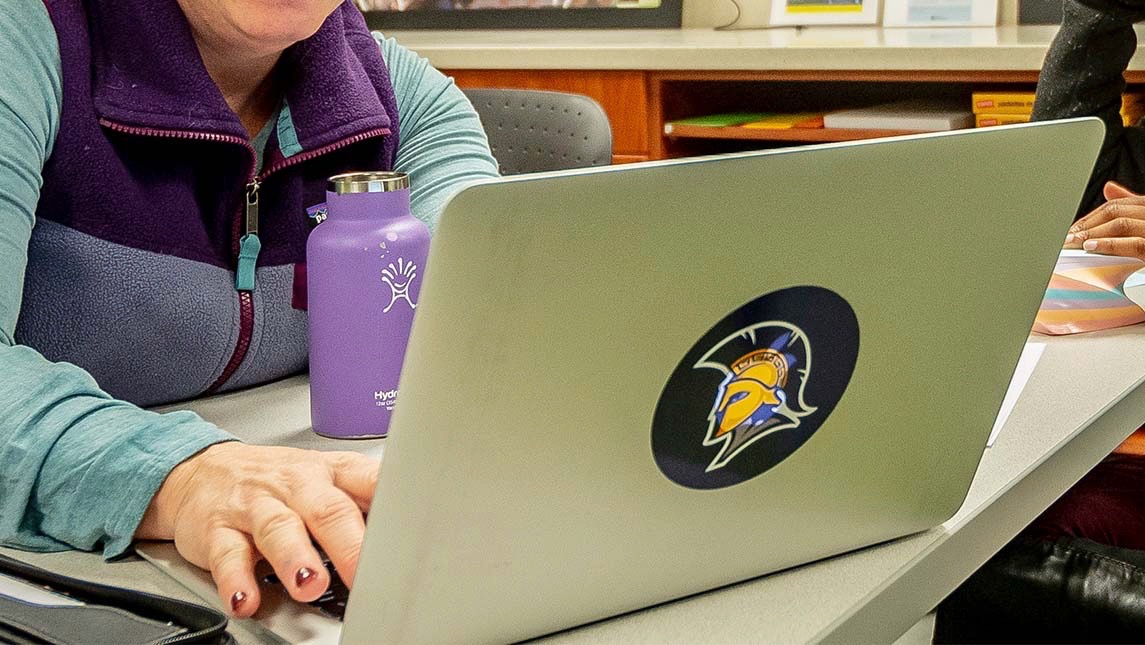Close up on a laptop with a UNCG Spartan sticker