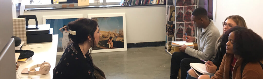 A group of Art School students gather for a discussion.