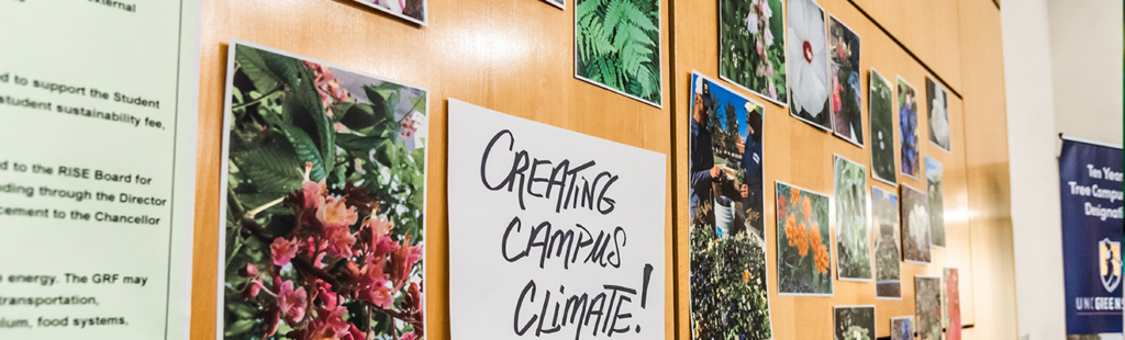 display board with nature photos and sign that reads "Creating Campus Climate!"