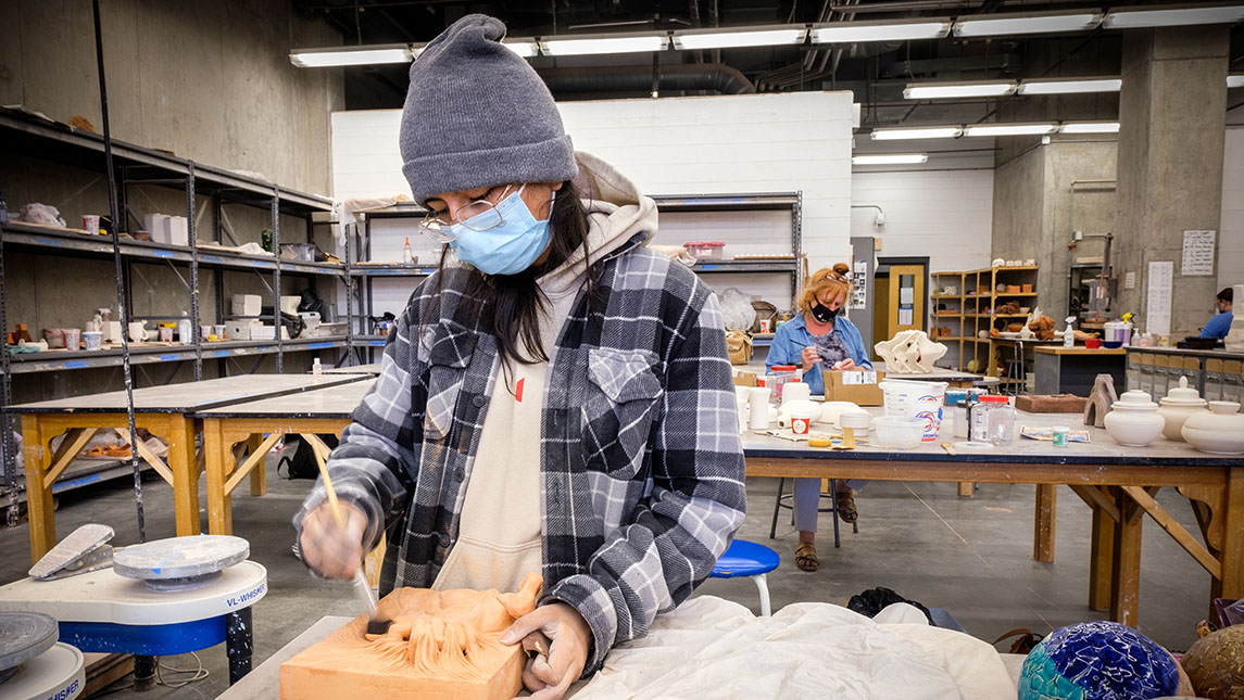 UNCG Student working in ceramic studio on Green Fund project
