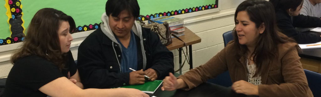 Instructors work with an adult learner as part of the Real World English program