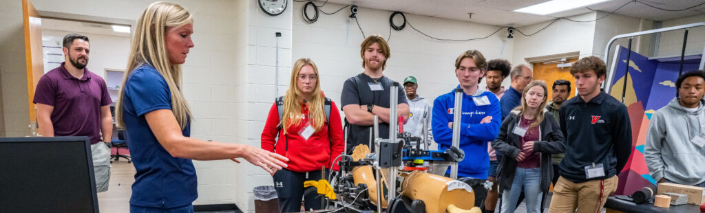 Students look at kinesiology equipment.