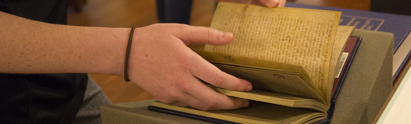 Katie Beeman examines a facsimile of the Gawain manuscripts.