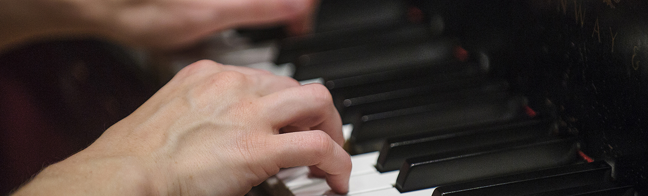 Pianist's hands at the keyboard.