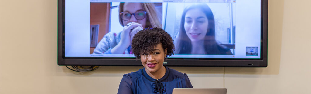 Library and Information Science students conversing in a hybrid classroom setting