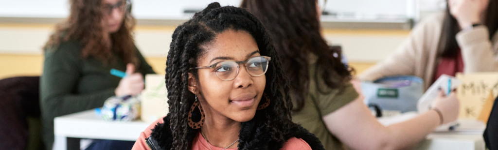 A student intently listens as part of a classroom presentation.