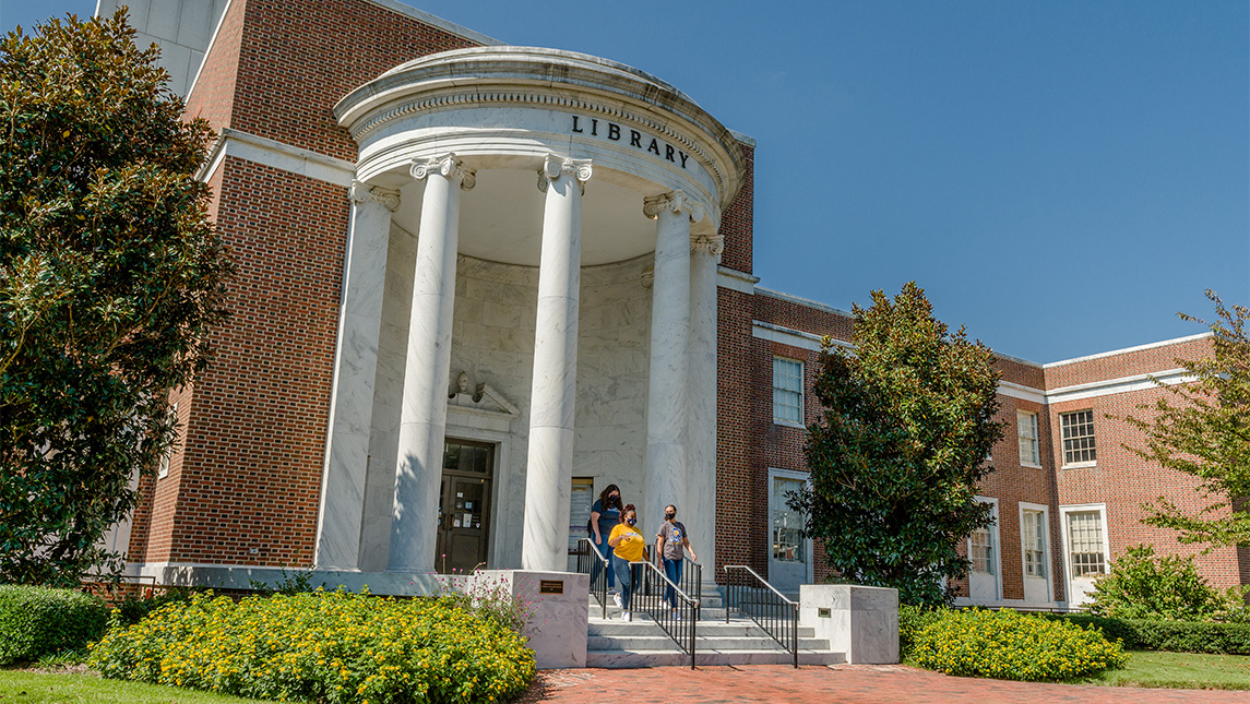 Students walk down the stairs of the UNCG Jackson Library.