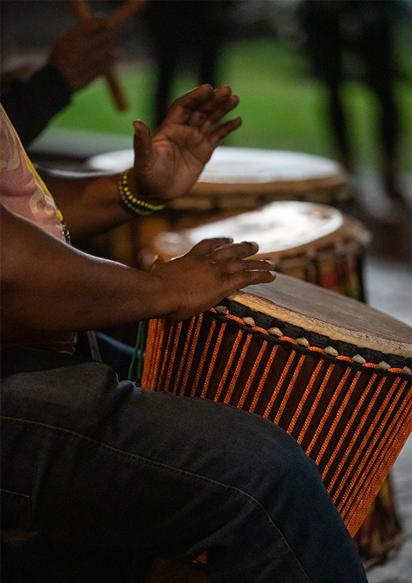 UNCG dance music coordinator Atiba Rorie plays drum at 2022 NC Folk Festival.
