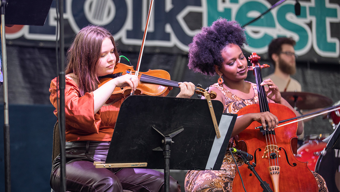Students play violin and cello at 2022 NC Folk Festival.