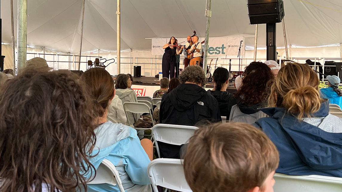 Band The Zinc Kings perform under tent at 2022 NC Folk Festival.