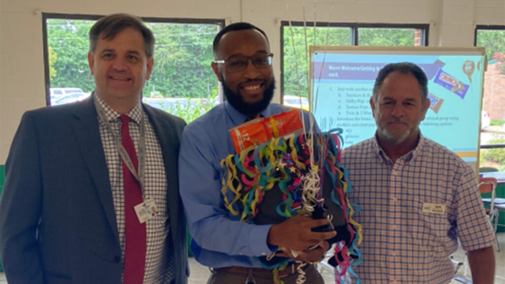 Justin Cunningham receives the Rockingham County Schools Beginning Teacher of Excellence award.