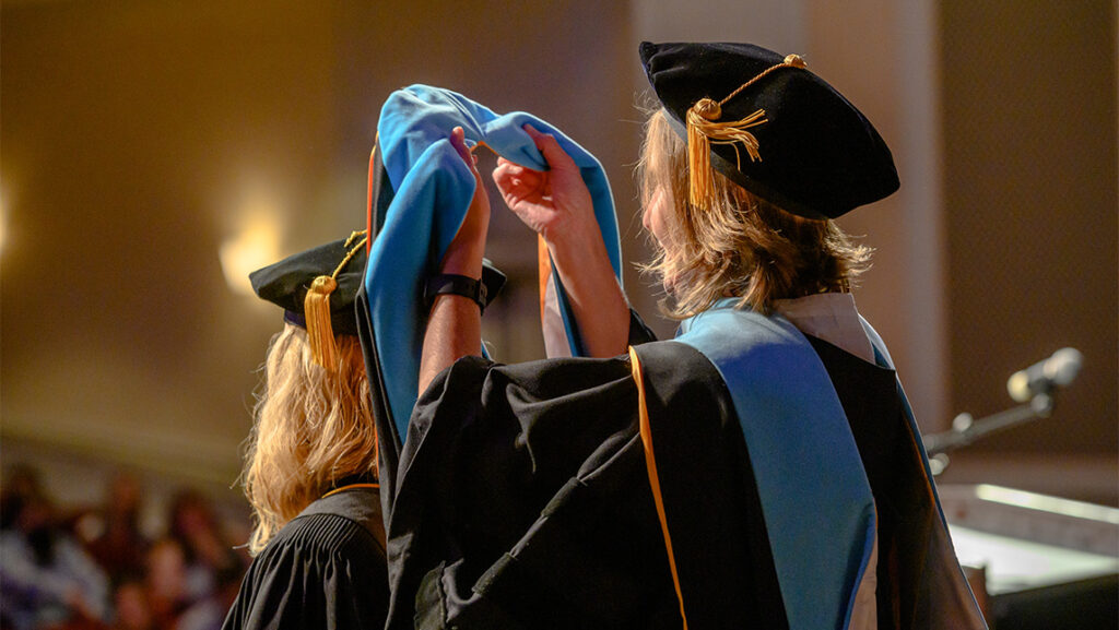 Graduate student receives her doctoral hood.