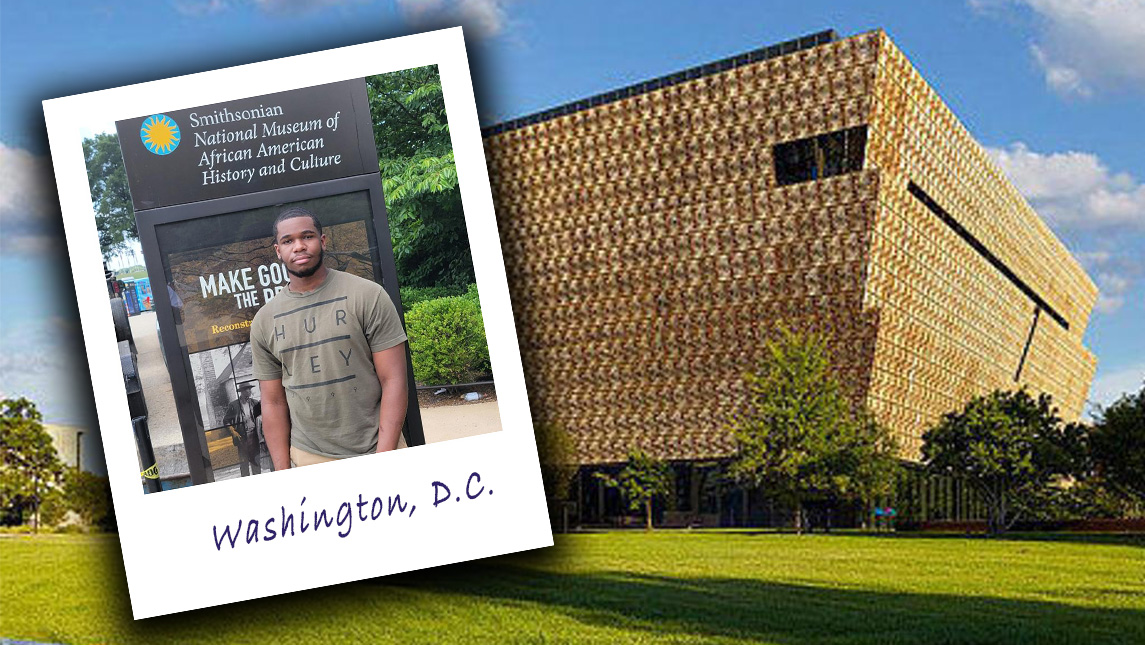 John Cooper stands in front of the sign to the Smithsonian National Museum of African American History and Culture.