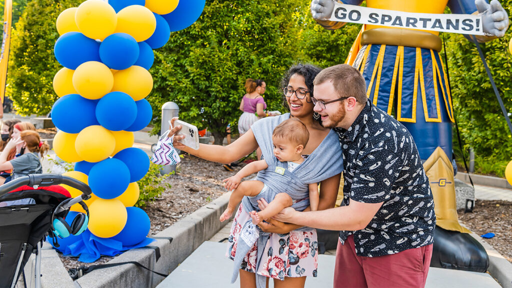 A family poses for a selfie in front of the inflatable Spiro.