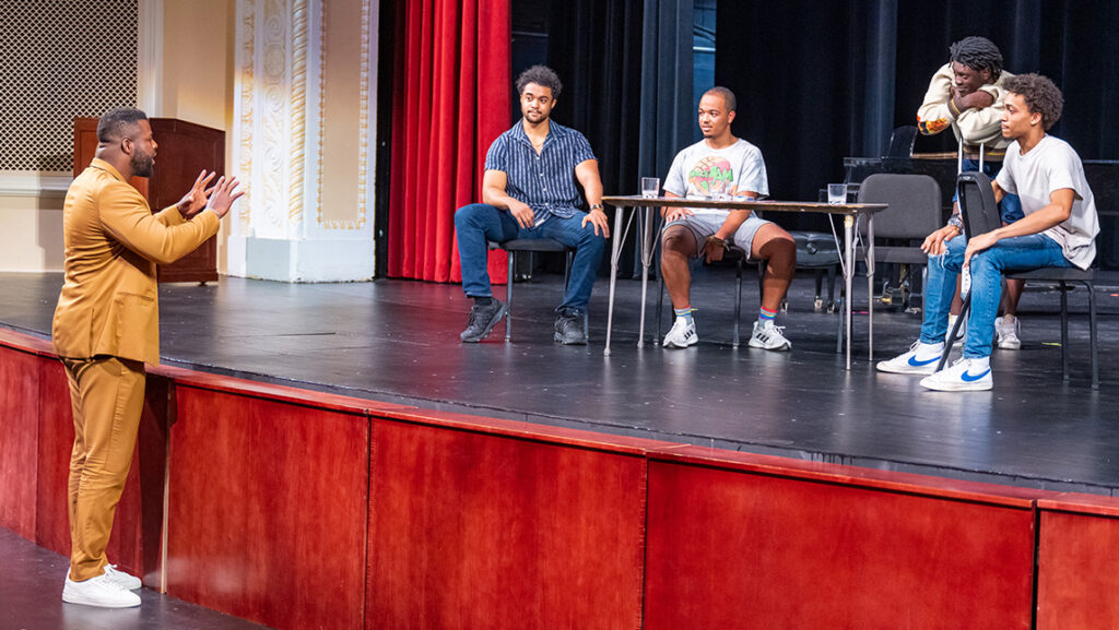 Winston Duke addresses drama students for a masterclass in the UNCG auditorium.