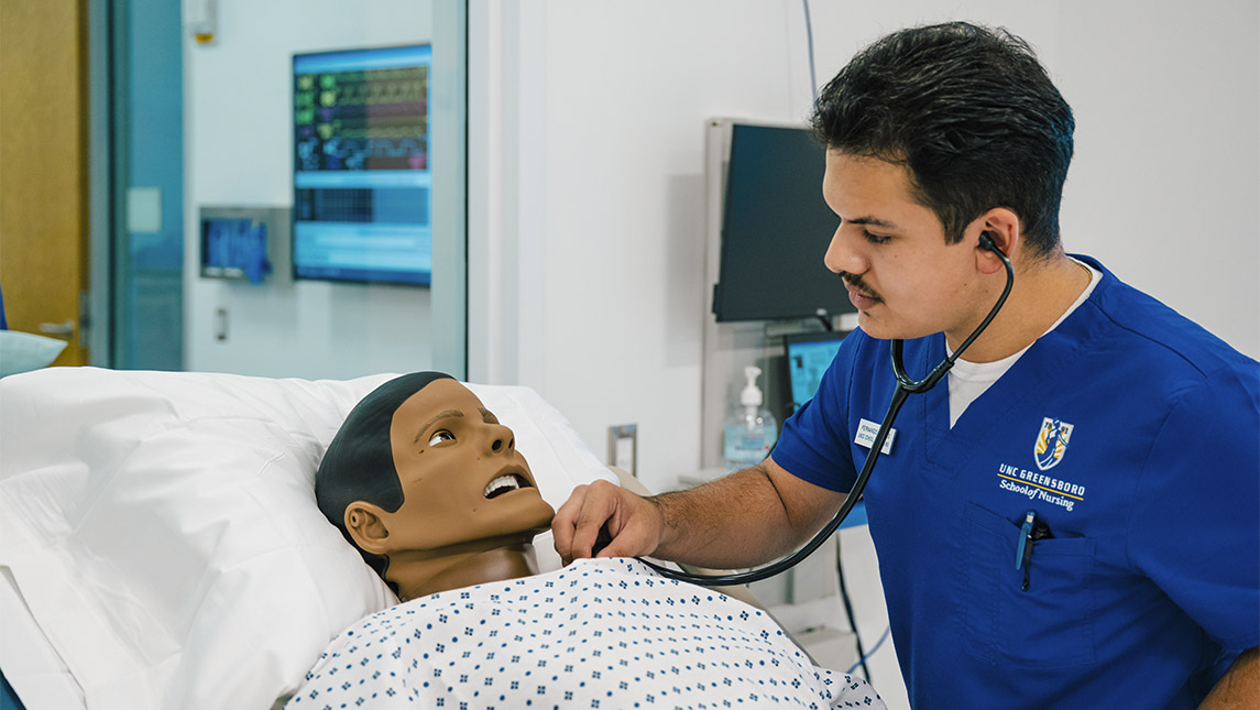 Lloyd International Honors College student Fernando Cuevas performs medical duties in a simulation lab at UNCG School of Nursing.
