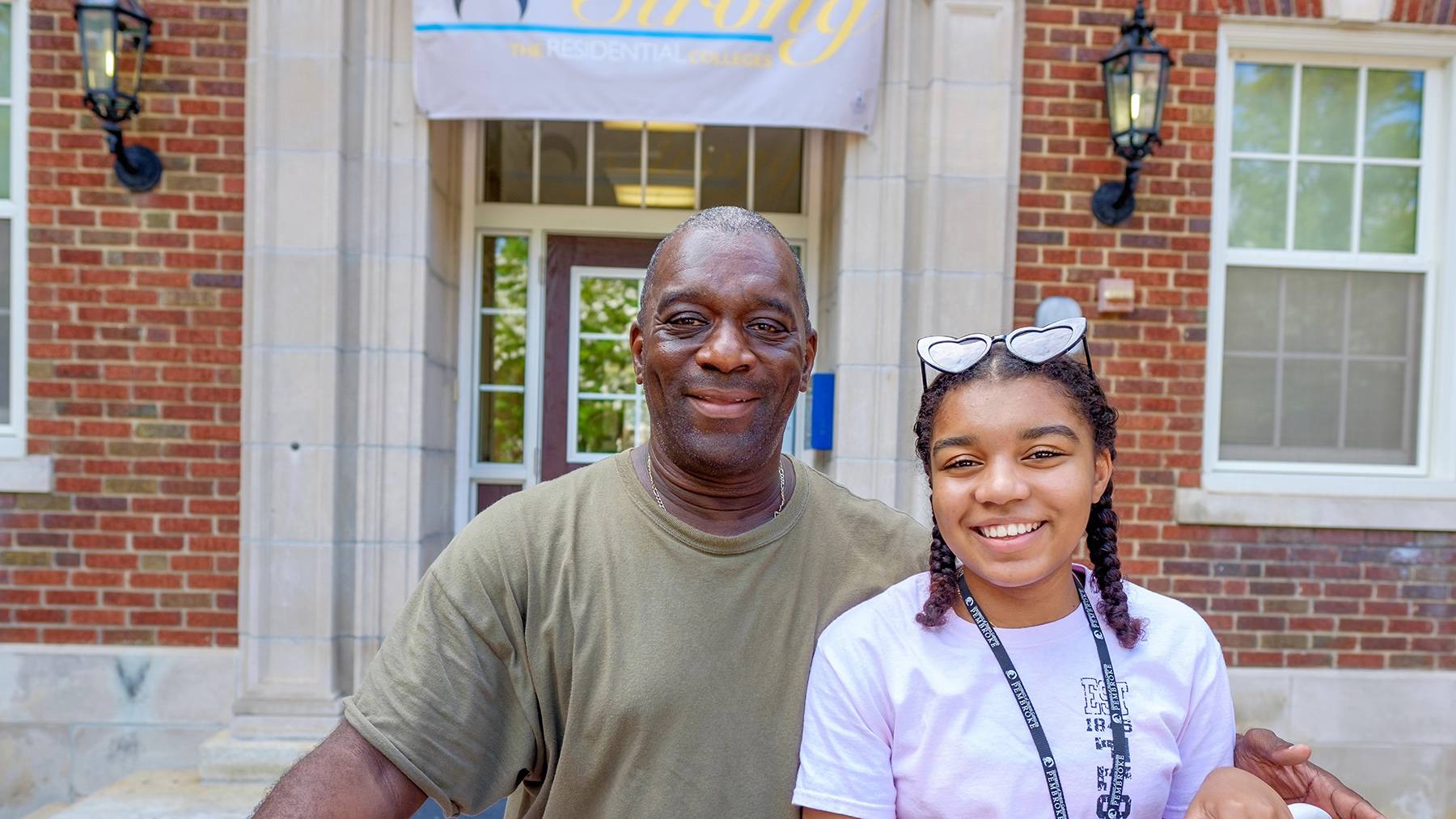 A father and daughter pose for a picture during Move-In Day.
