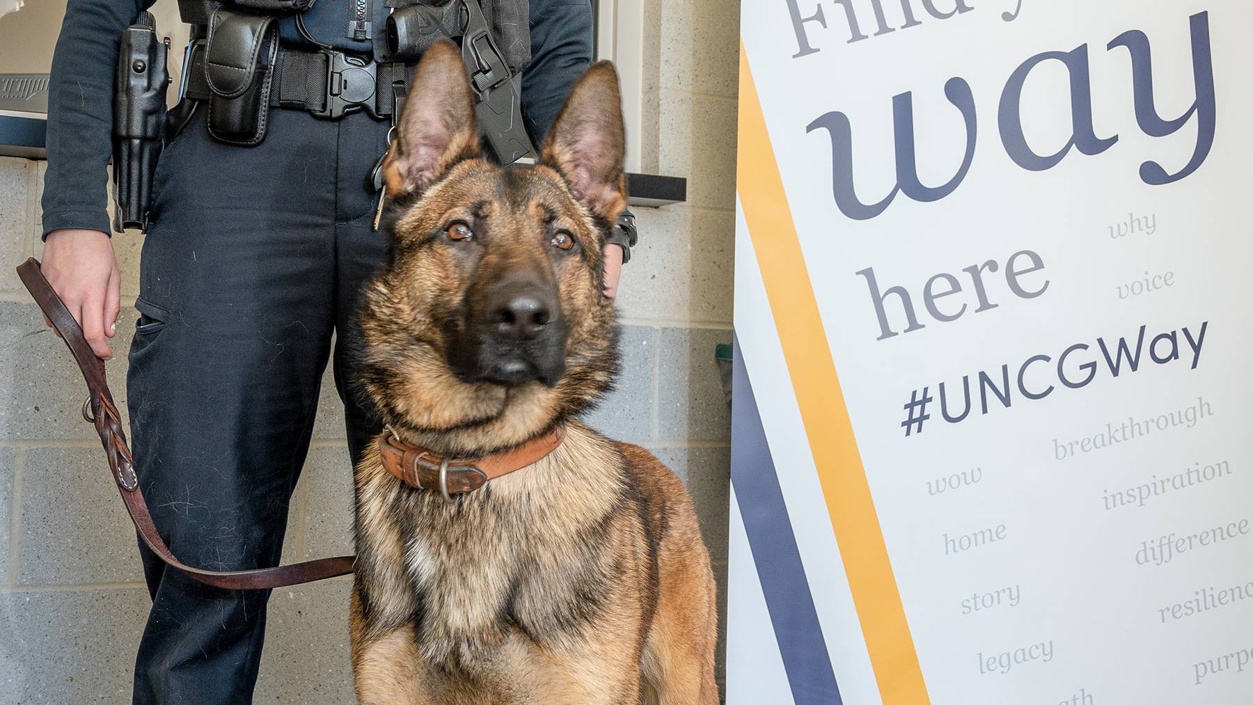 A UNCG police officer and her K-9 partner pose for a picture.
