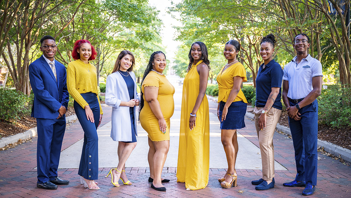 UNCG Homecoming Royal Court stands on campus