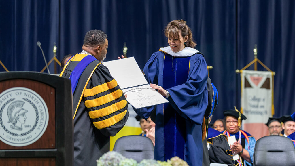 Actress Beth Leavel receives an honorary degree from UNCG Chancellor Gilliam at the 2022 Spring Commencement.