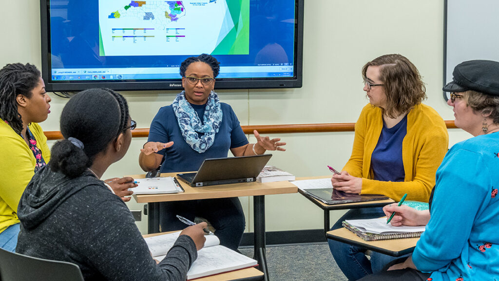 Students and faculty put their desks in a circle for a close-knit discussion in the School of Education.