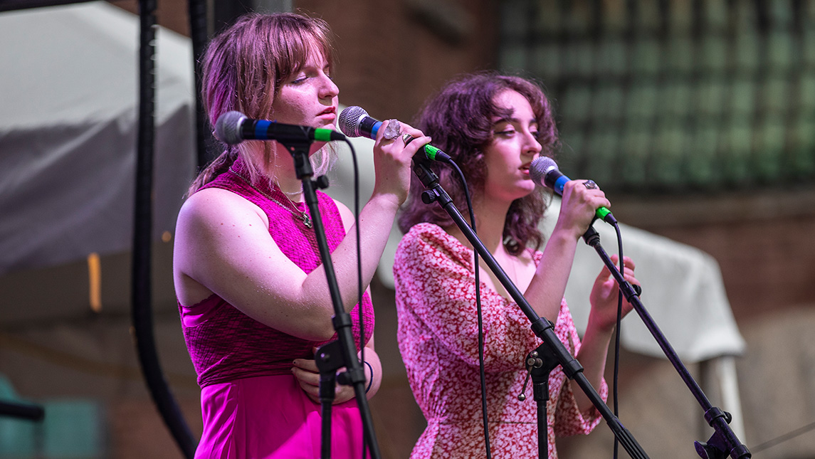 UNCG students Clara Lampkin and Lora Mouna sing in a contemporary music band at the 2022 NC Folk Festival.