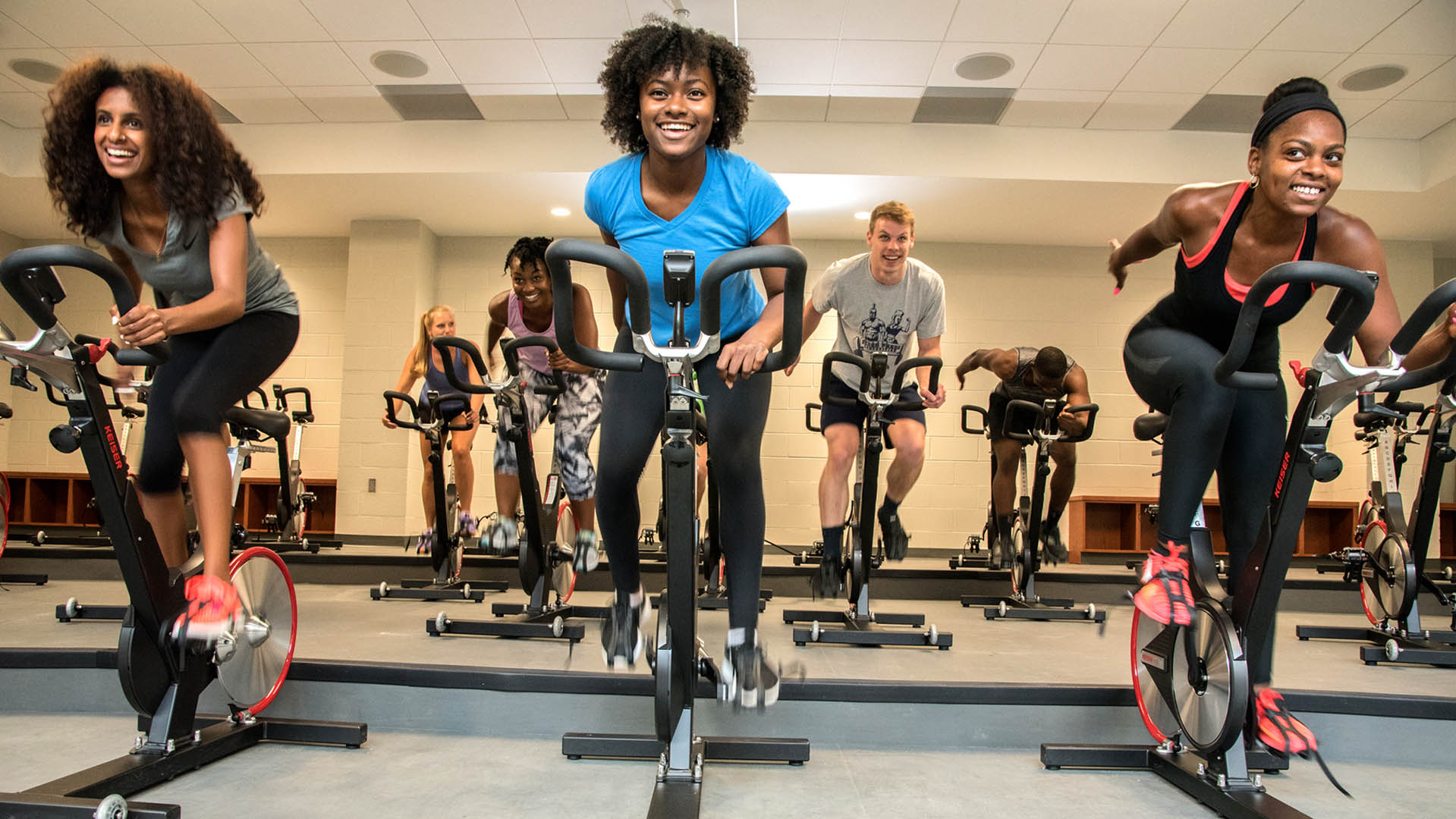 Students taking a cycle class in the Kaplan Center