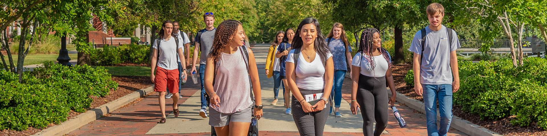 Students walking on College Avenue on UNCG's campus