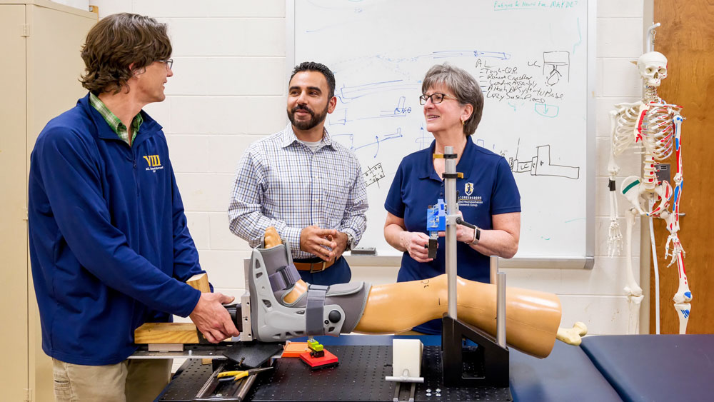Dr. Sandra Shultz and Dr. Randy Schmitz, both professors in Kinesiology and co-directors of UNCG's Applied Neuromechanics Research Laboratory, and LaunchUNCG Program Manager Sam Seyedin discuss a device to measure knee laxity that Shultz and Schmitz are working to patent.
