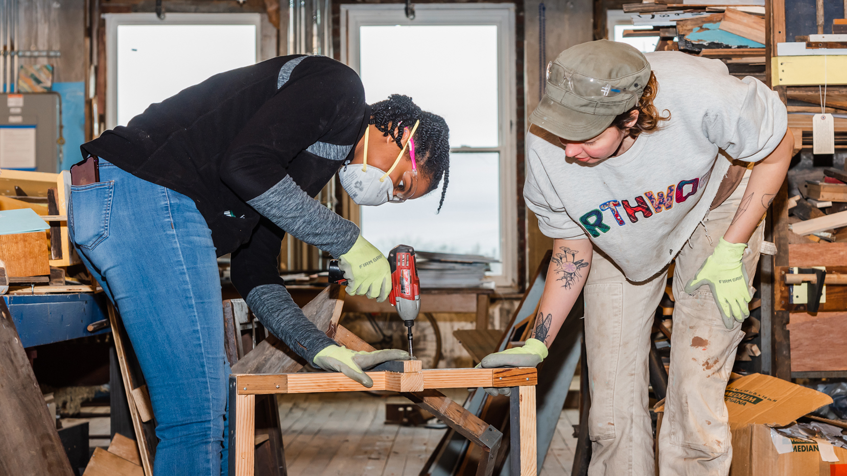 Two students work together to drill wood pieces during the annual MLK Day of Service.