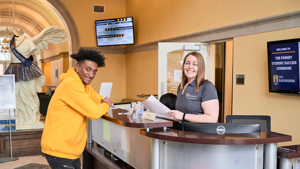 Student and staff member in the Forney Student Success Commons.