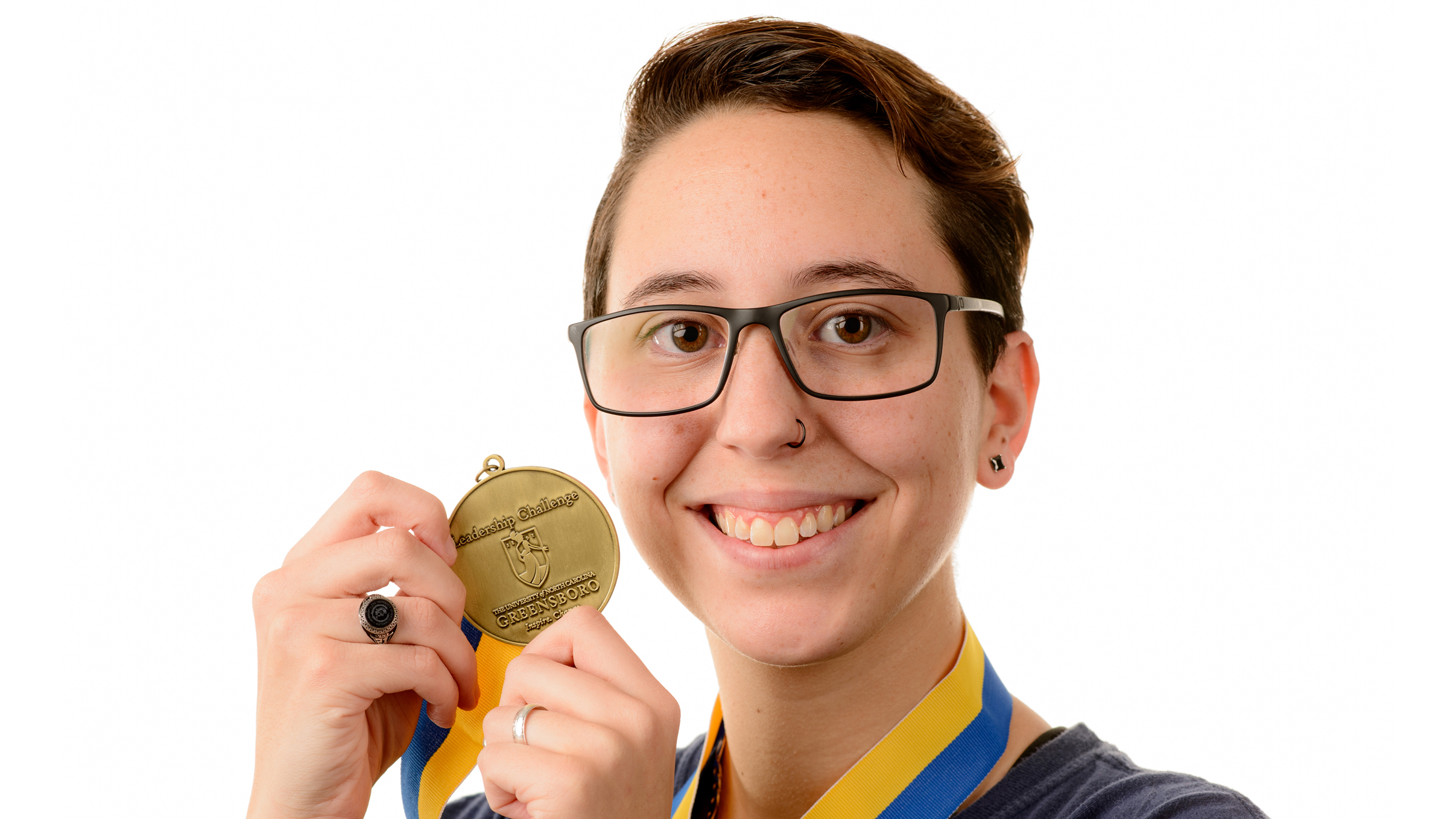 UNCG student Bri Ferraro poses for a portrait with her Leadership Challenge medal.