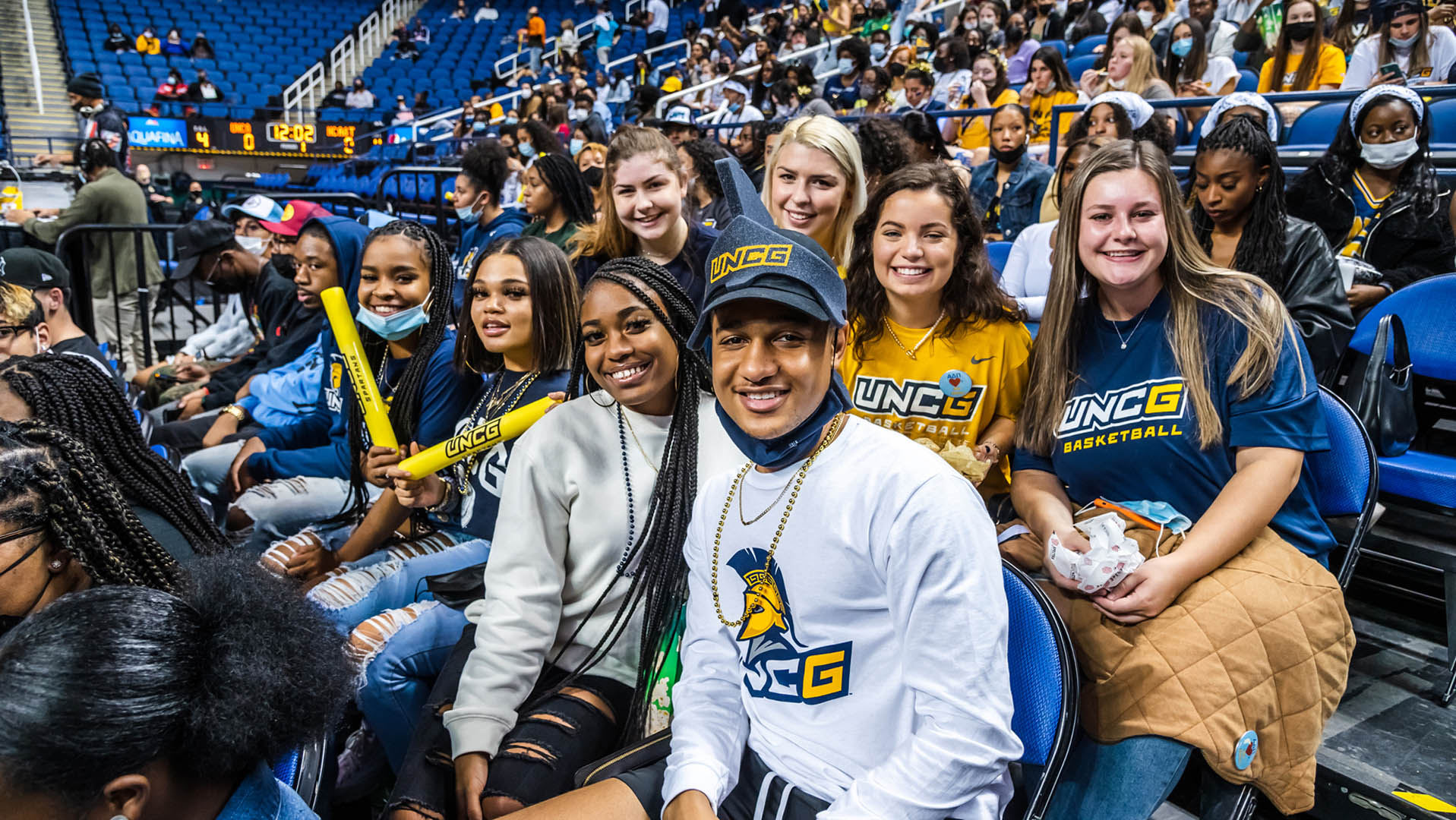 A group of students pose for a picture at a men’s basketball game at the Greensboro Coliseum.