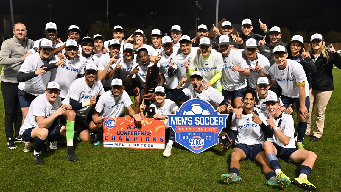 The men's soccer team and their coaches gather to celebrate their 2022 Southern Conference championship victory.
