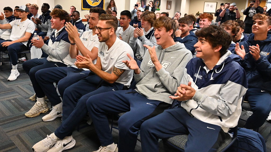 Men's soccer team applaud after hearing the lineup for their 12th bid to the NCAA Division I Championship.