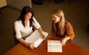 A Writing Center consultant and consultee work together on a paper.