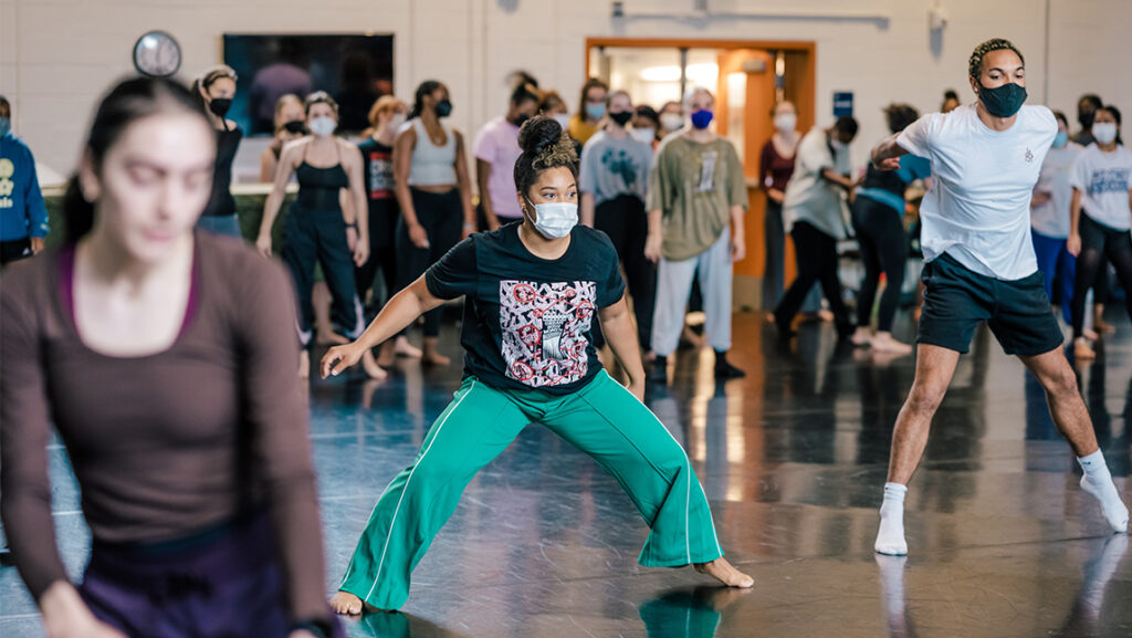 UNCG alumna Shayla Taylor with the Urban Bush Women dances alongside students in a studio classroom.