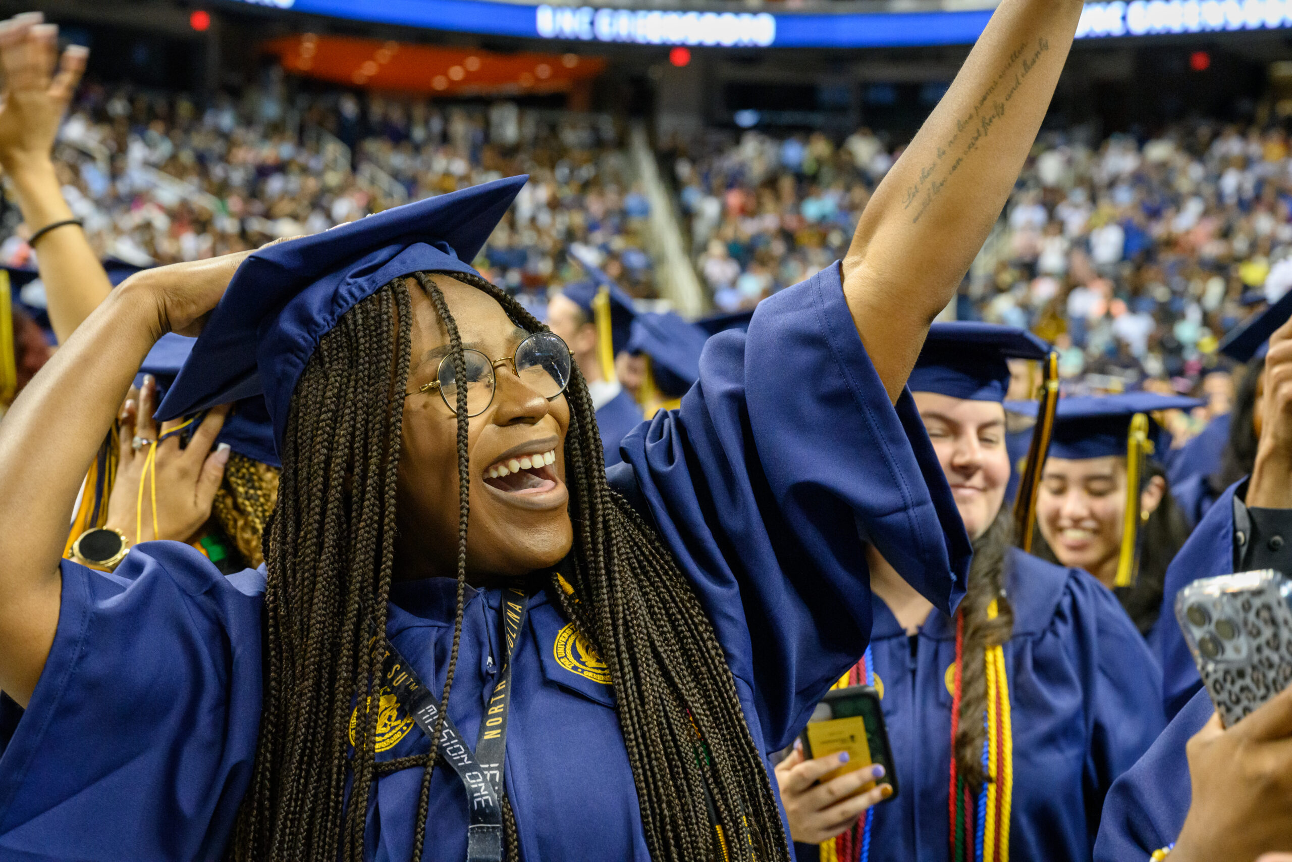 Student in graduation robe at UNCG Spring Commencement 2022