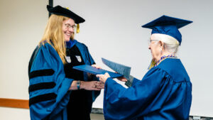 Bonnie Miller receives her LLC diploma.