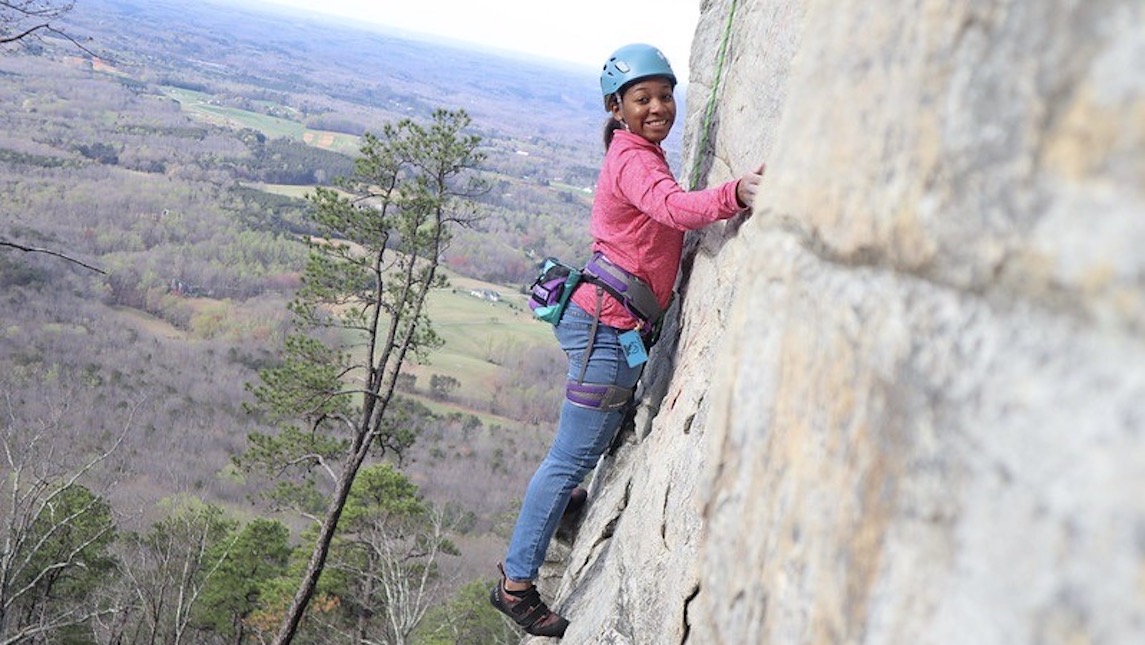 OA team member climbs the side of Pilot mountain.