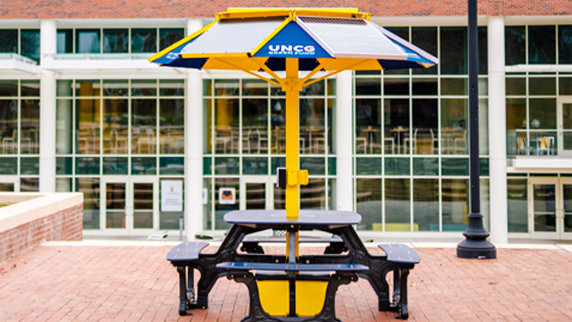 A solar-powered picnic table on Morans Commons Plaza