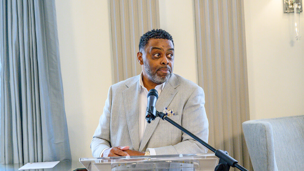 Chancellor Gilliam speaks at a podium during a staff appreciation event.