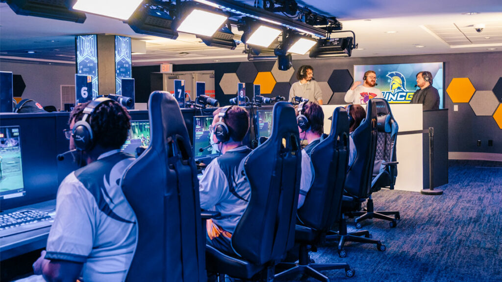 Gamers compete in the UNCG Esports arena while shoutcasters call the game for the stream.