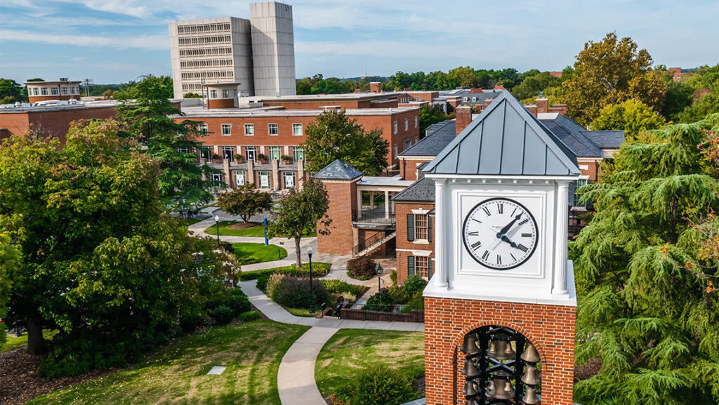 Landscape picture shows the UNCG clocktower, the NIB building, and the library.