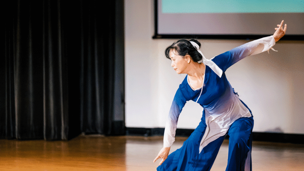 Woman on stage presents Kung-fu dancing method