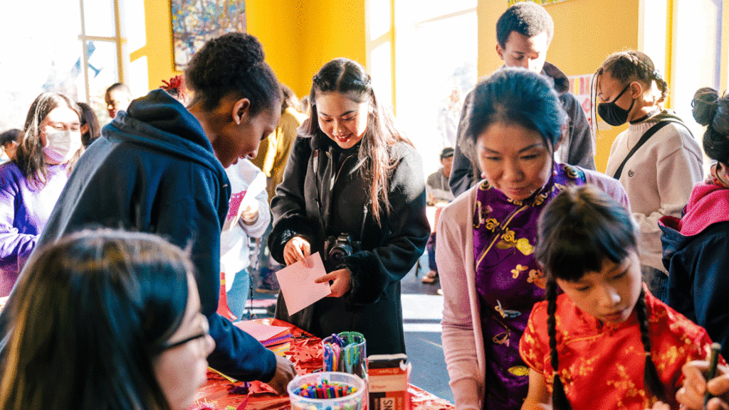 a crowd gathers around a table