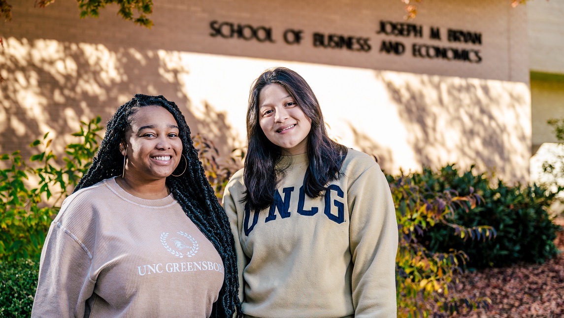 Two female Bryan School students in front of building